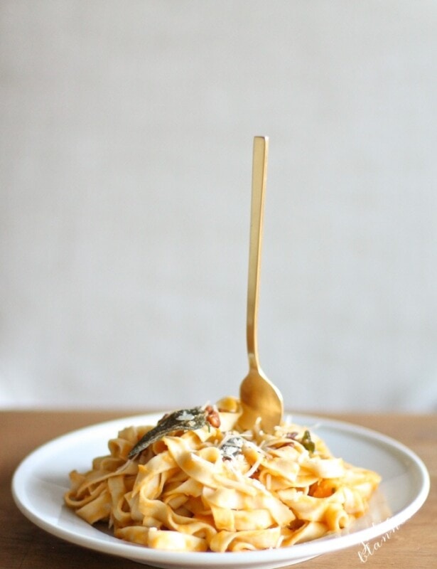 butternut squash pasta on white plate with fork sticking up