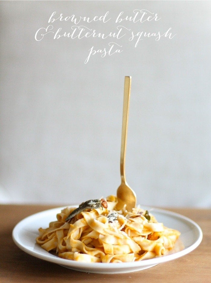 butternut squash pasta on a white plate with gold fork sticking out