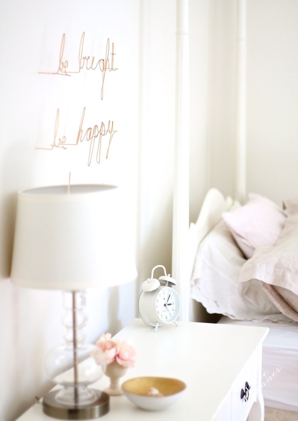 A girl's bedroom featuring gold wire wall art