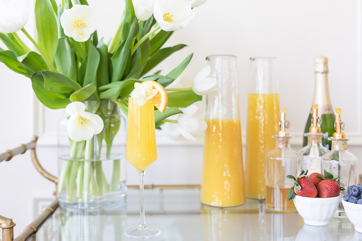 Gold bar cart decorations with a self serve mimosa set up!