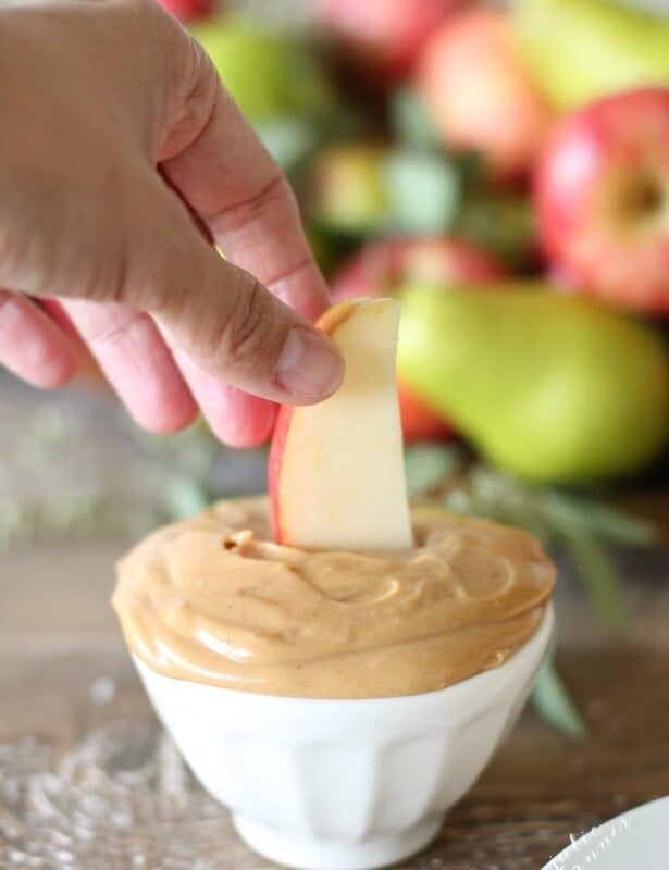 dipping an apple in peanut butter fruit dip