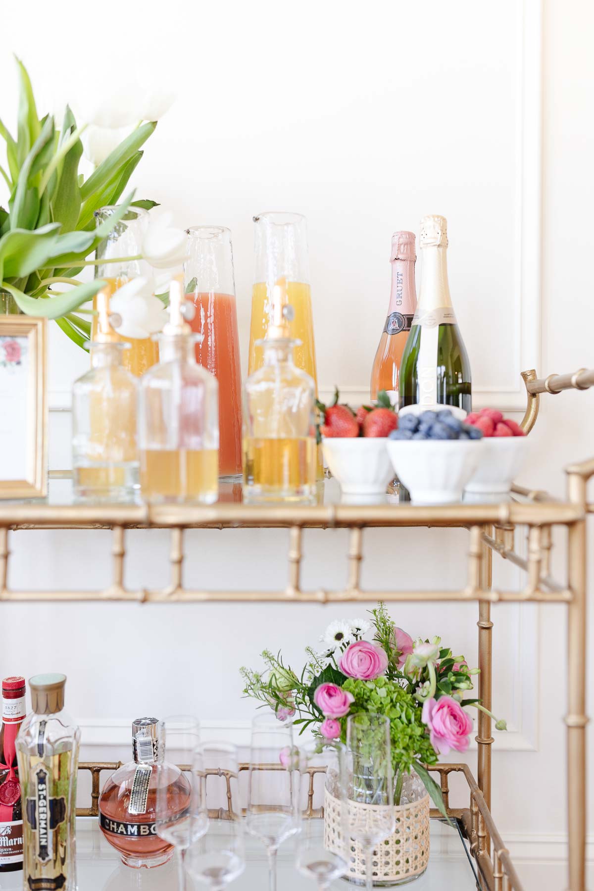 Bar cart decor styled with self serve mimosas.