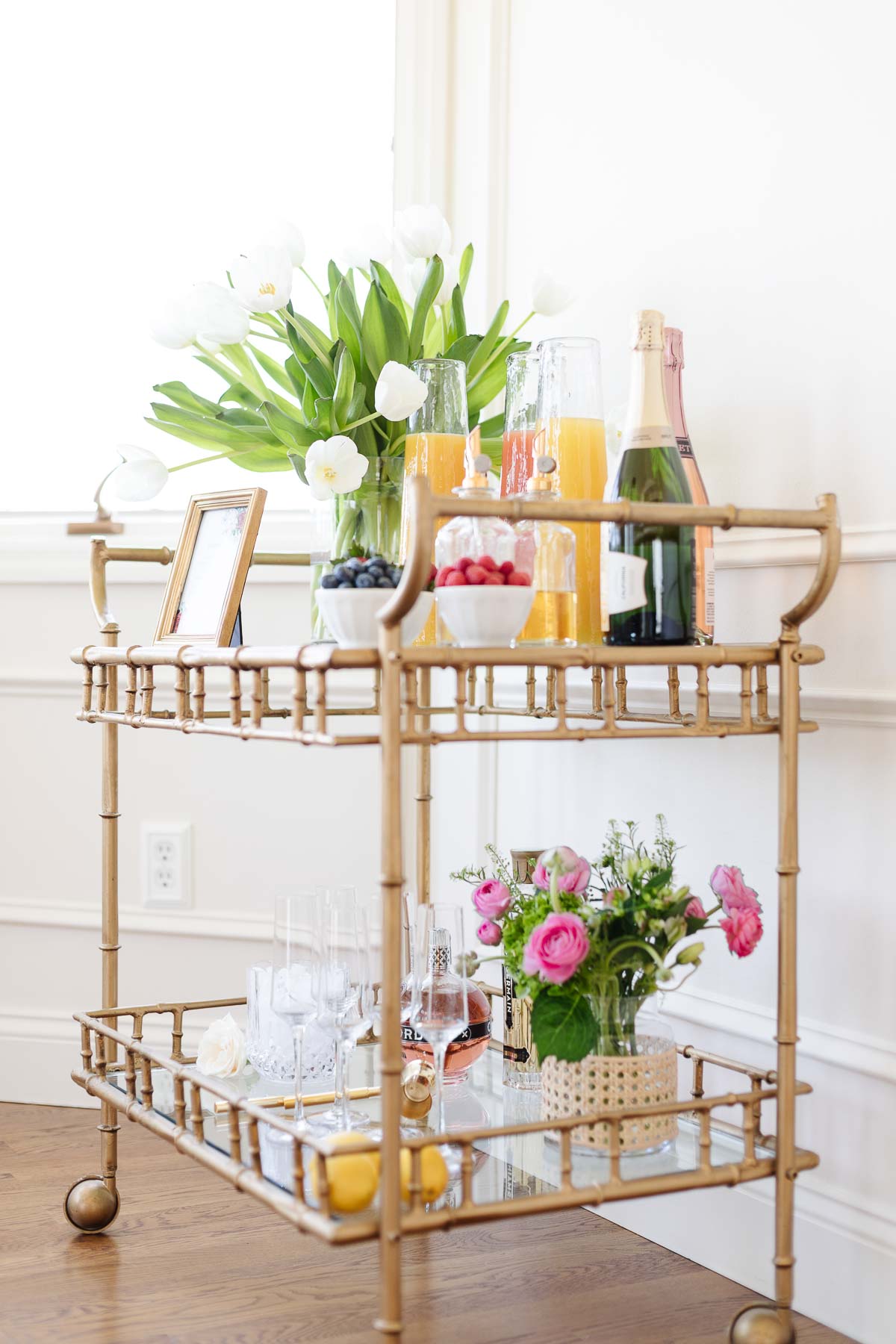 Bar cart decor styled with self serve mimosas.