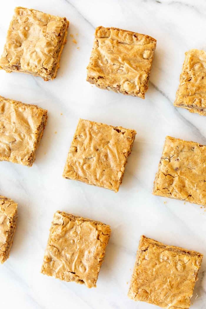 homemade pecan pie bars with graham cracker crust on marble countertop