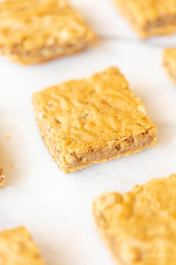 pecan pie bars cut into squares on white surface