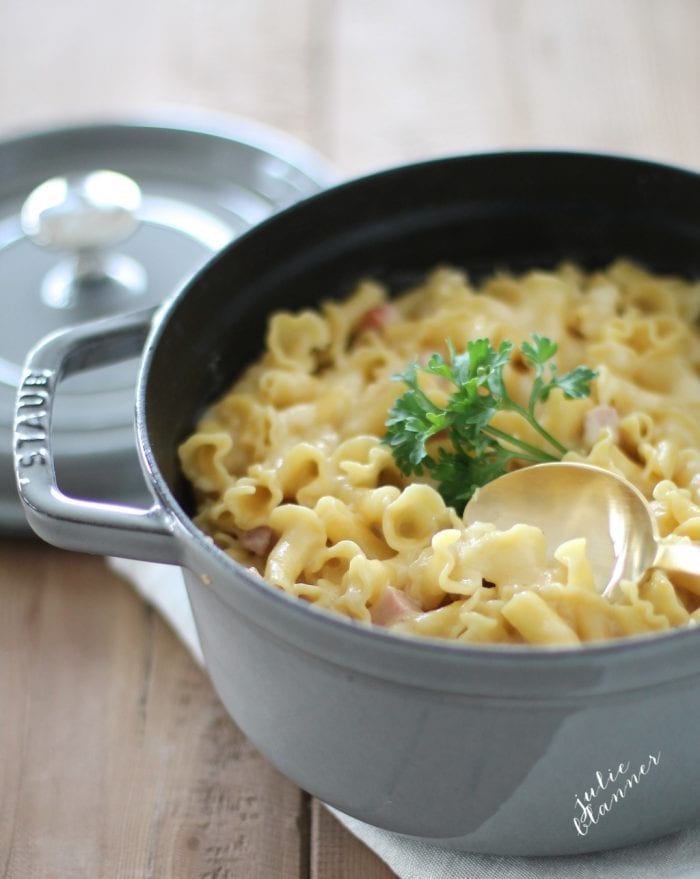 The best baked Truffle Mac and Cheese with Smoked Gouda is an easy side dish or entree that's creamy and full of flavor! Simply decadent and delicious. baked smoked gouda mac and cheese in a gray dutch oven with gold serving spoon