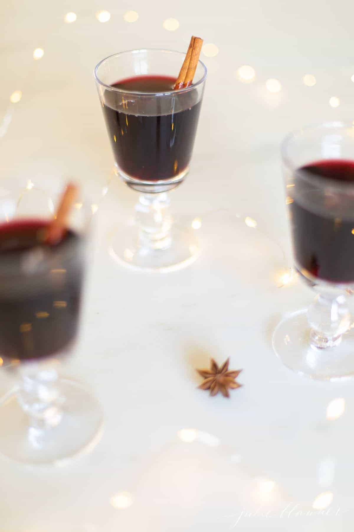 Three clear glasses full of warmed mulled wine for an easy Thanksgiving Recipe
