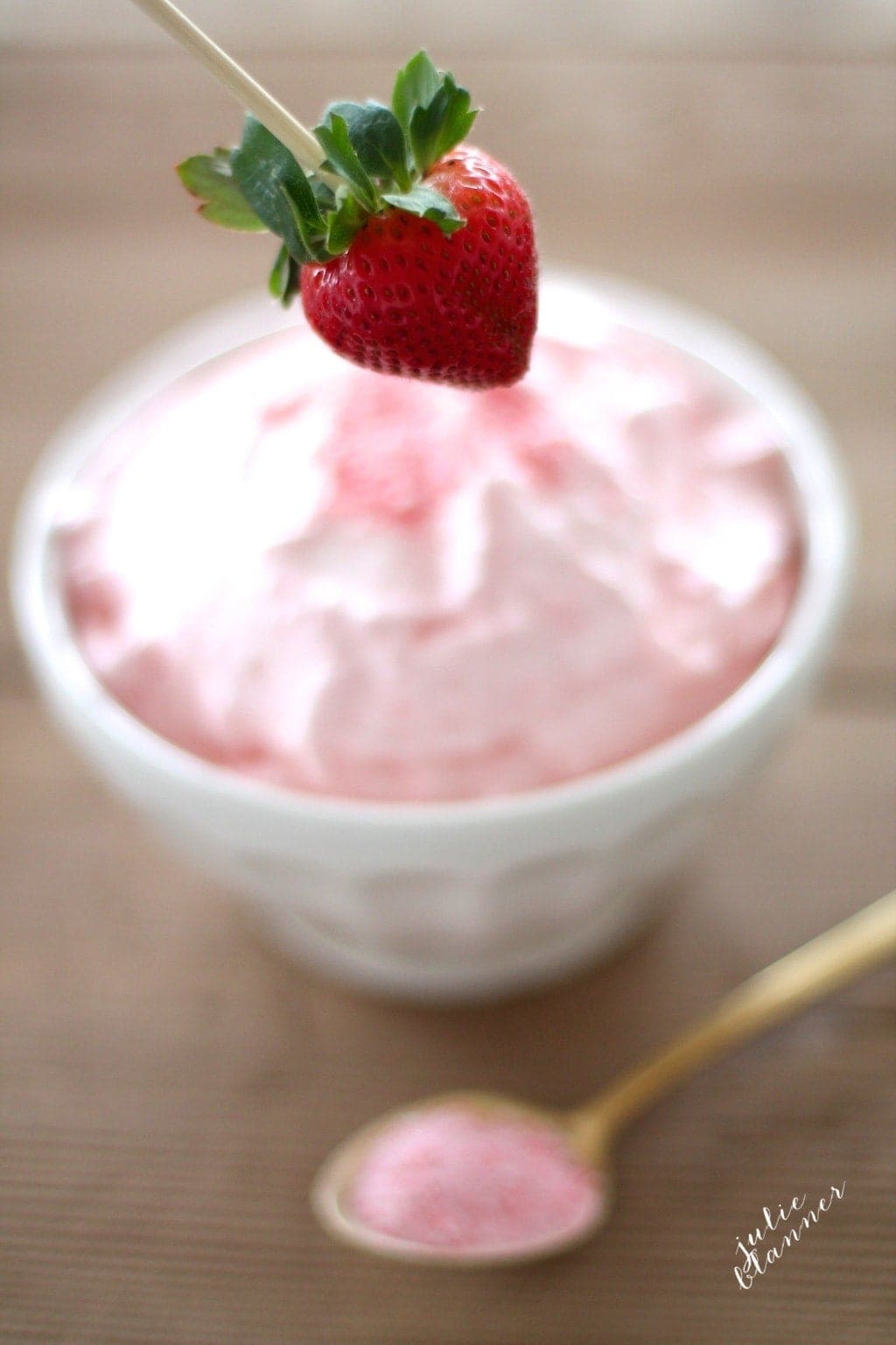 Close up of a strawberry infront of the dip