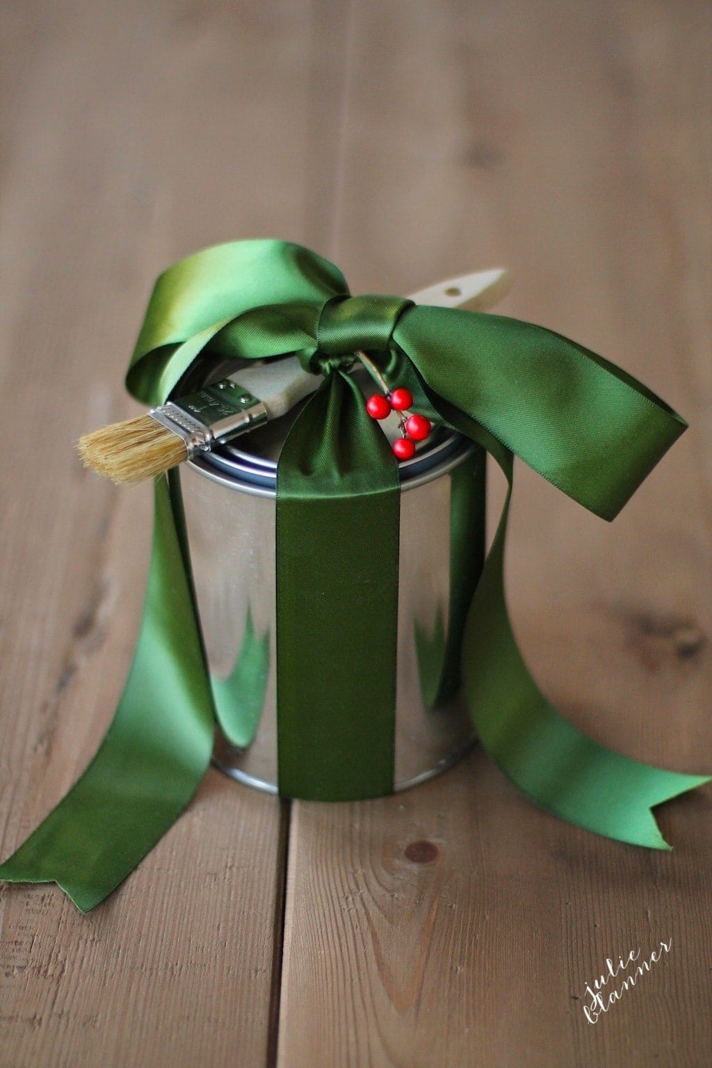 Paint can with a green bow on top