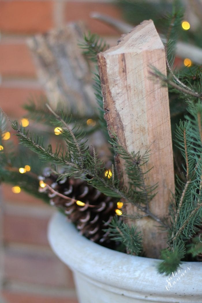 Twinkle lights make the outdoor arrangement festive for Christmas