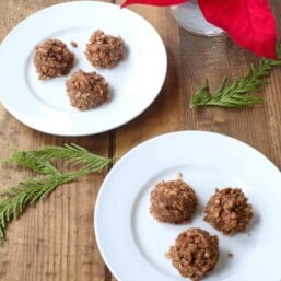 Two small white plates with chocolate no bake cookies on top.