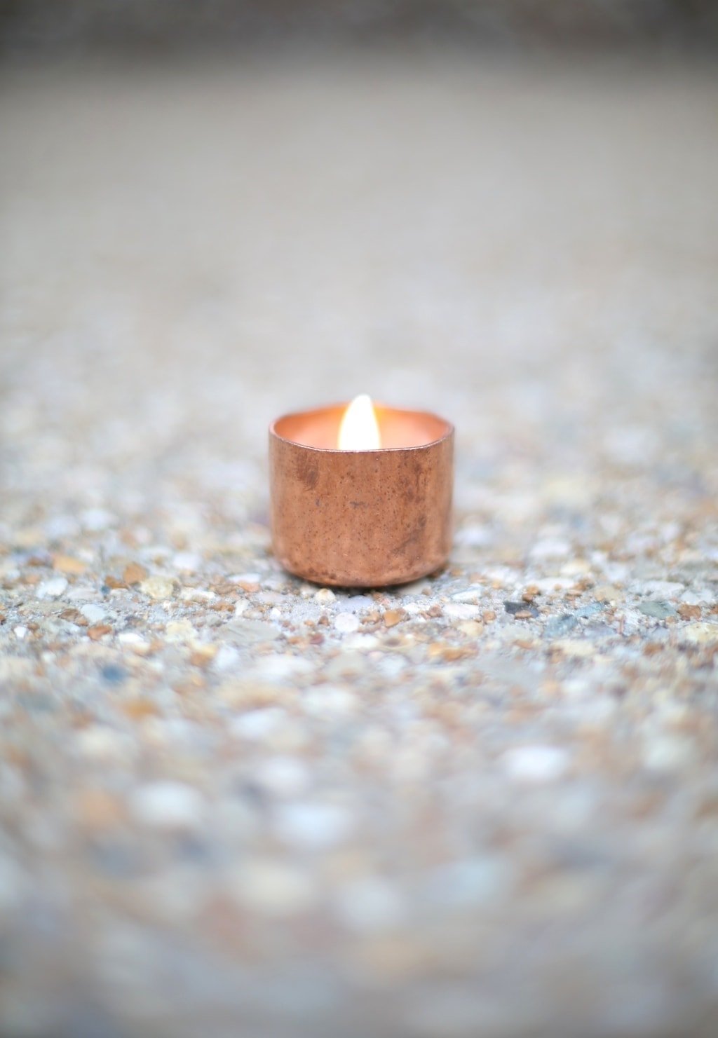 A small, copper tealight lining a path