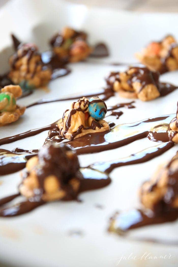 Cookies lined up on a baking sheet and drizzled with chocolate