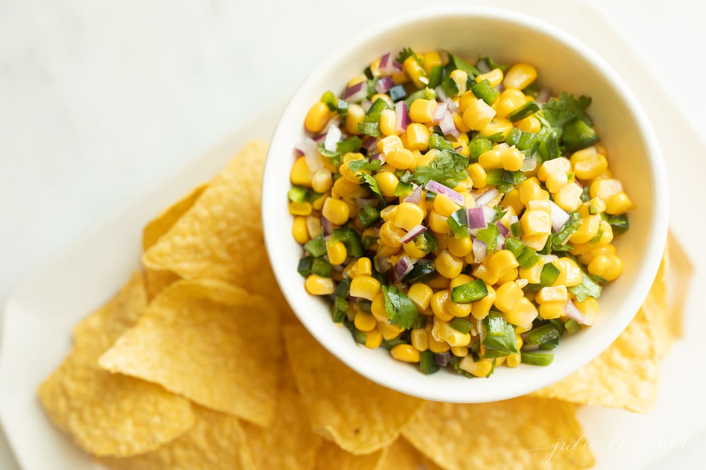 chipotle corn salsa in a bowl with chips surrounding it