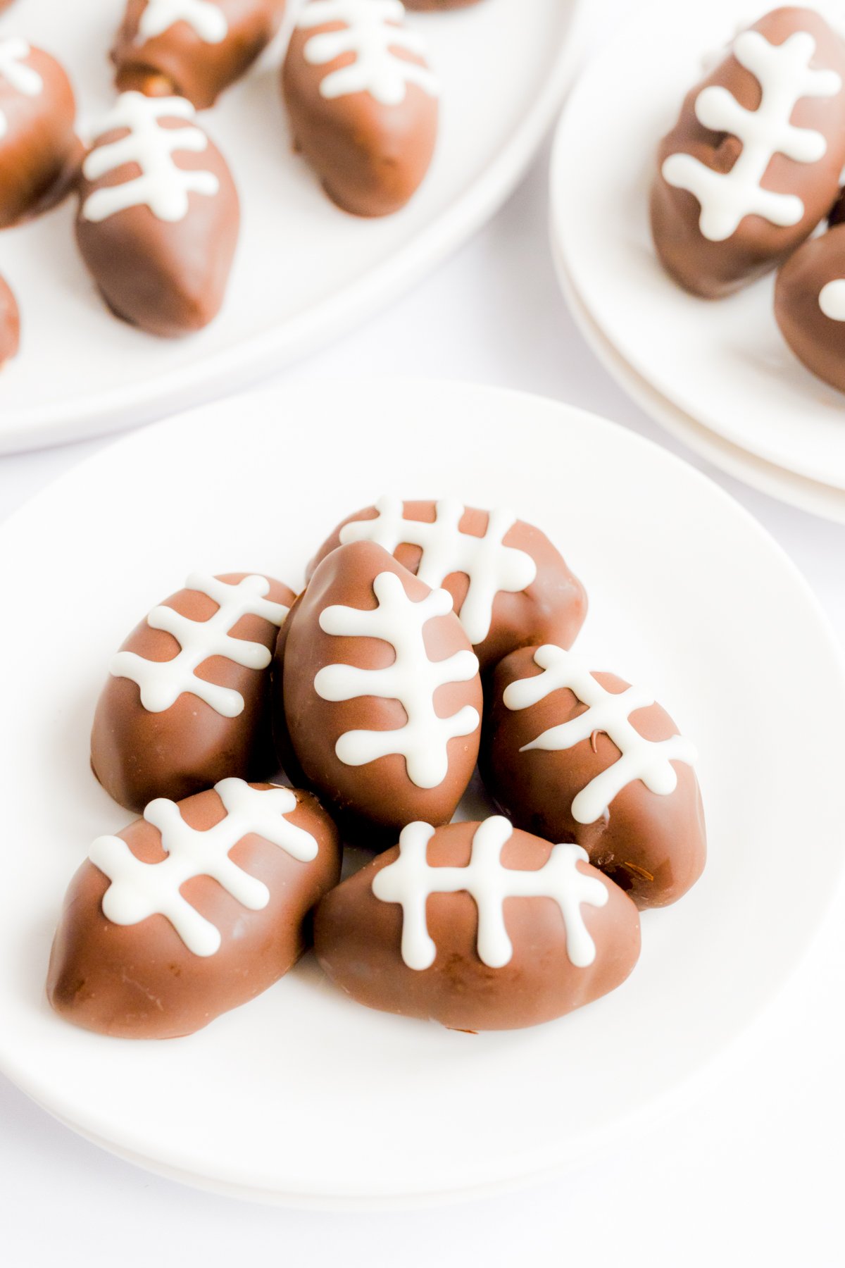 A plate of peanut butter truffles shaped like footballs.