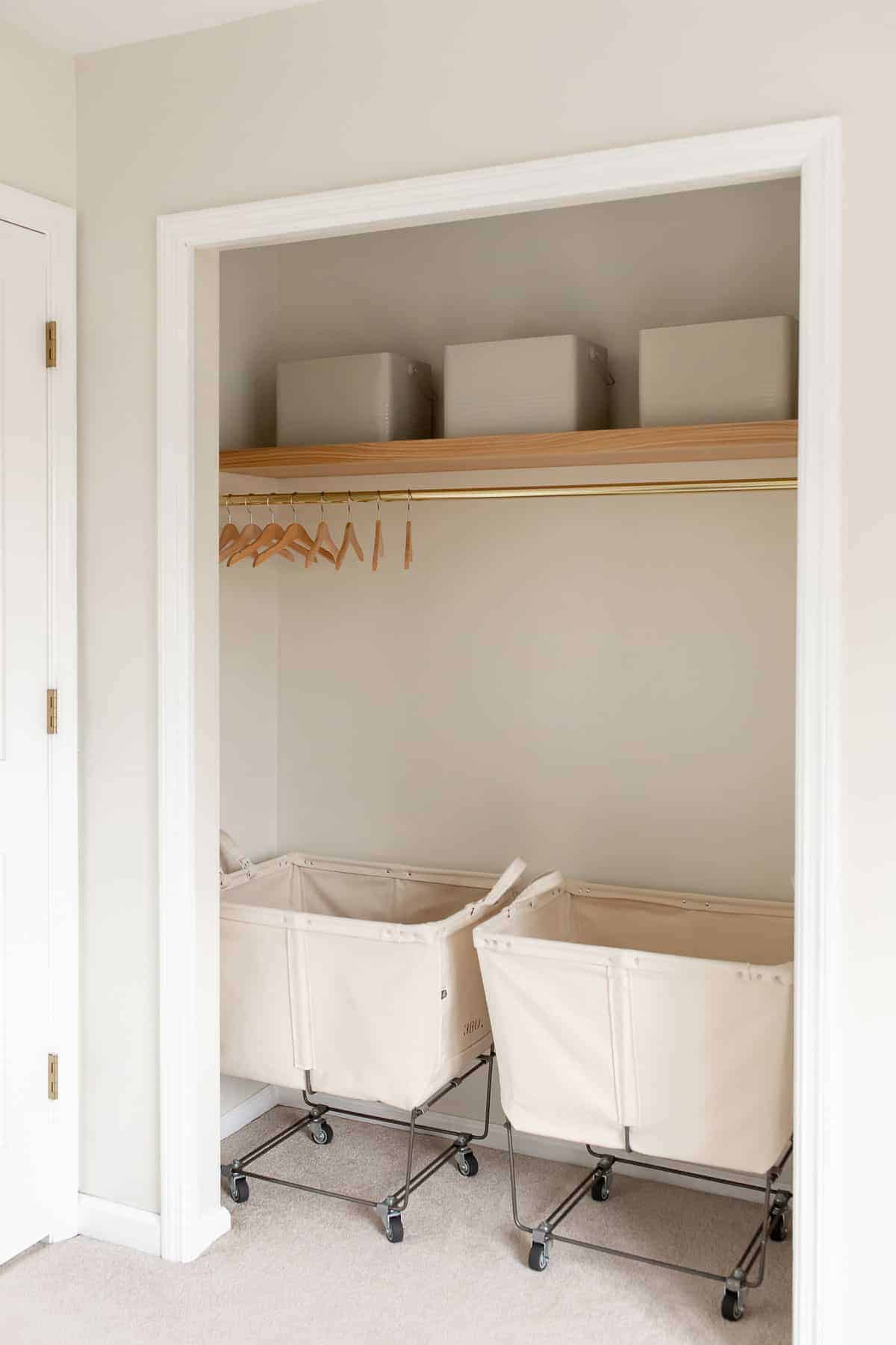 laundry closet with floating shelf and 2 laundry carts