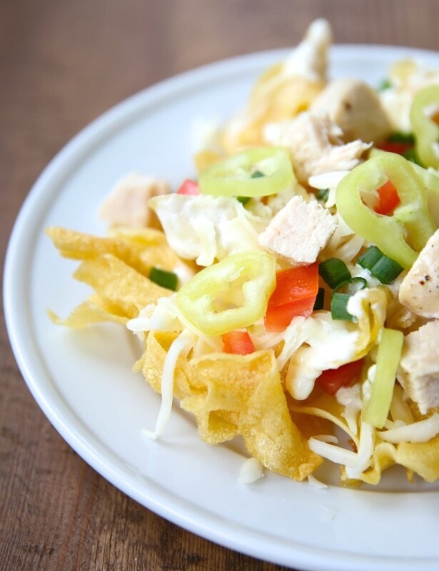 Incredible Italian nachos recipe with asiago cream sauce on a bed of pasta chips!