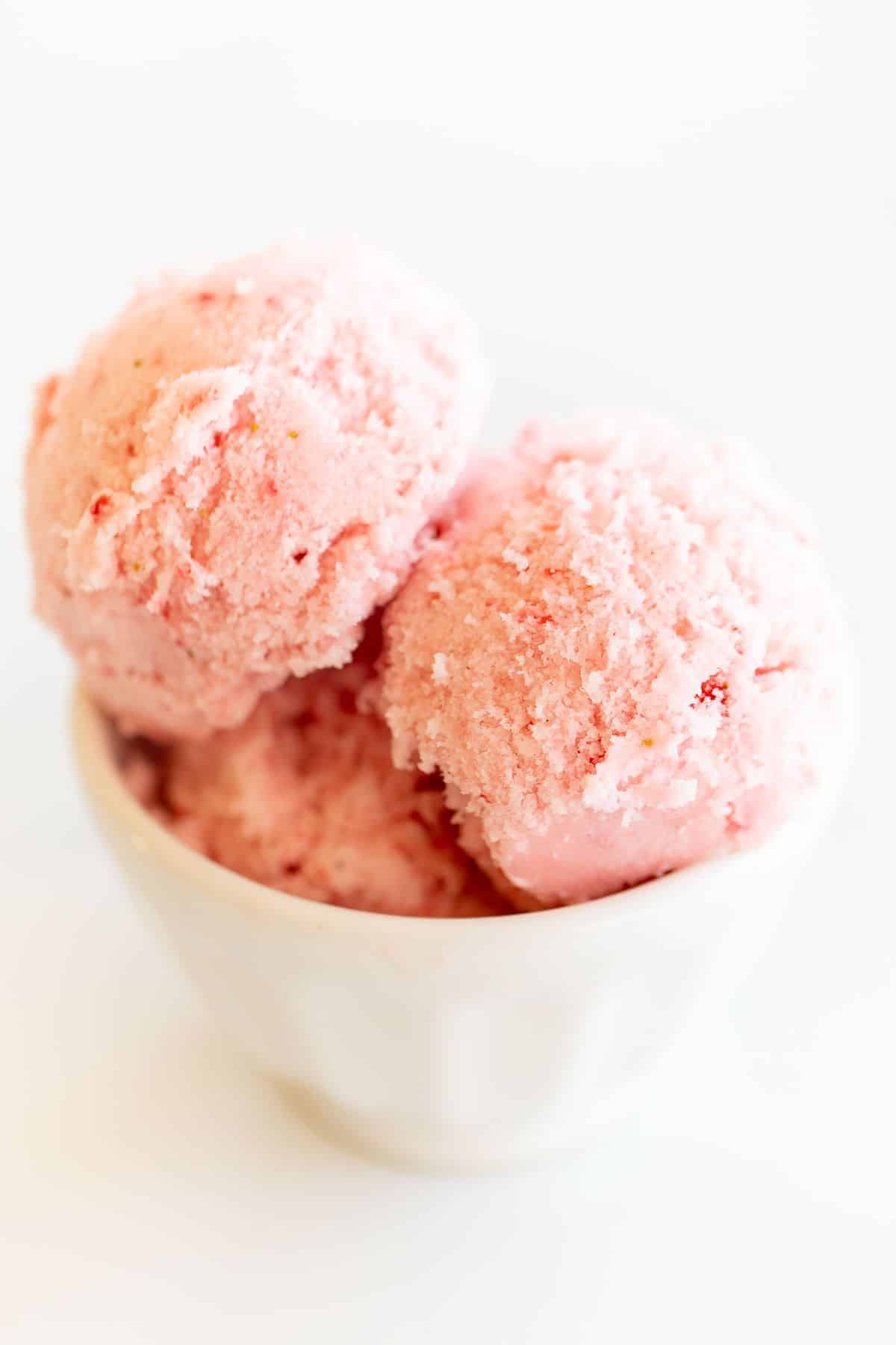 A white bowl of strawberry snow ice cream.