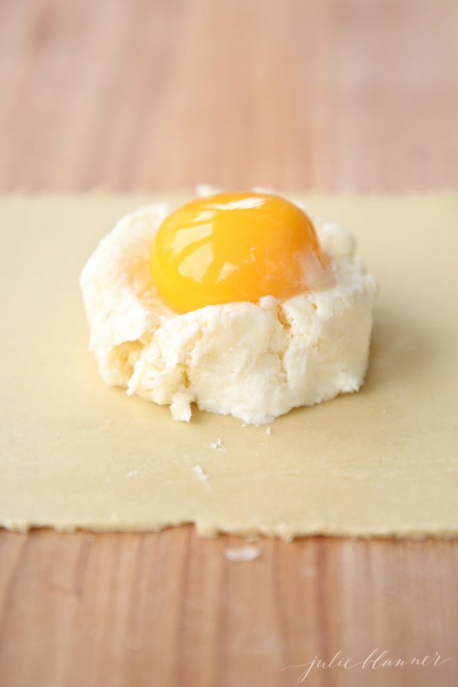 An egg yolk placed on top of the cheese mixture