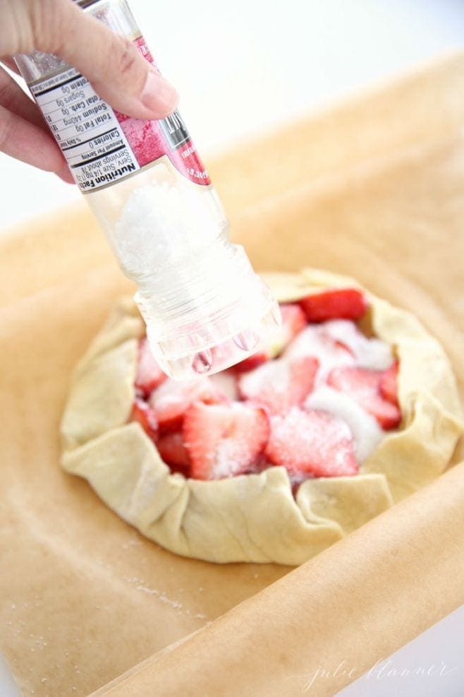 Adding salt to the strawberries and sugar