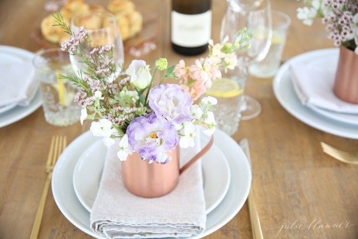 Beautiful Mother's Day brunch table setting idea with diy flower arrangements that double as take home favors