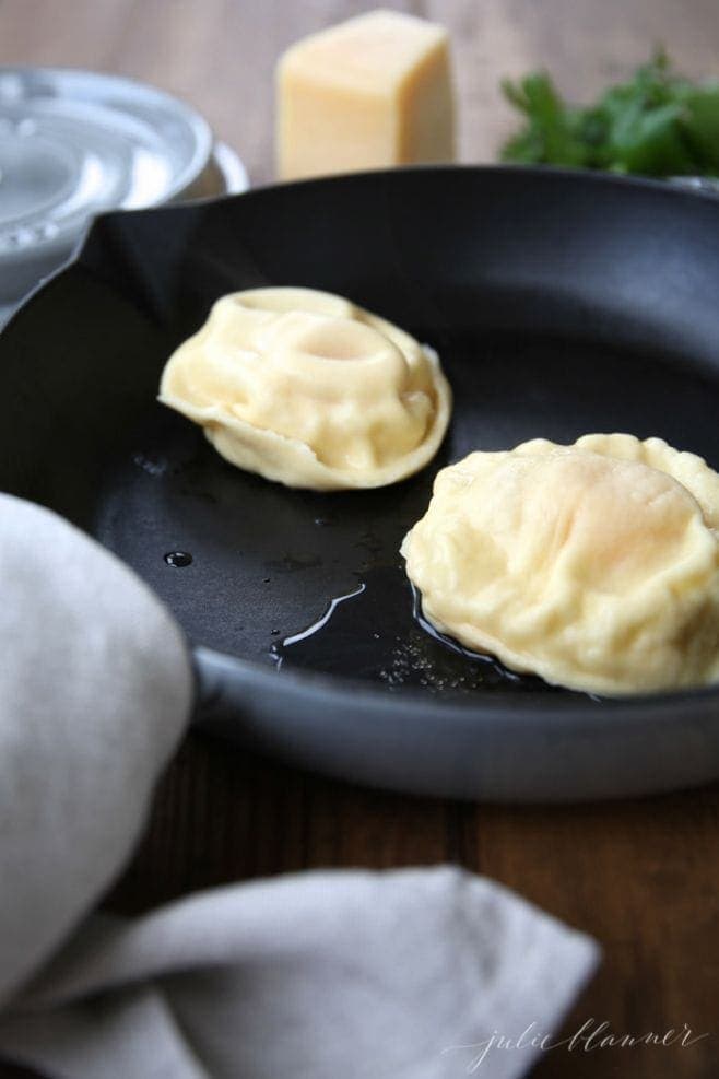 The cooked homemade egg ravioli in a skillet