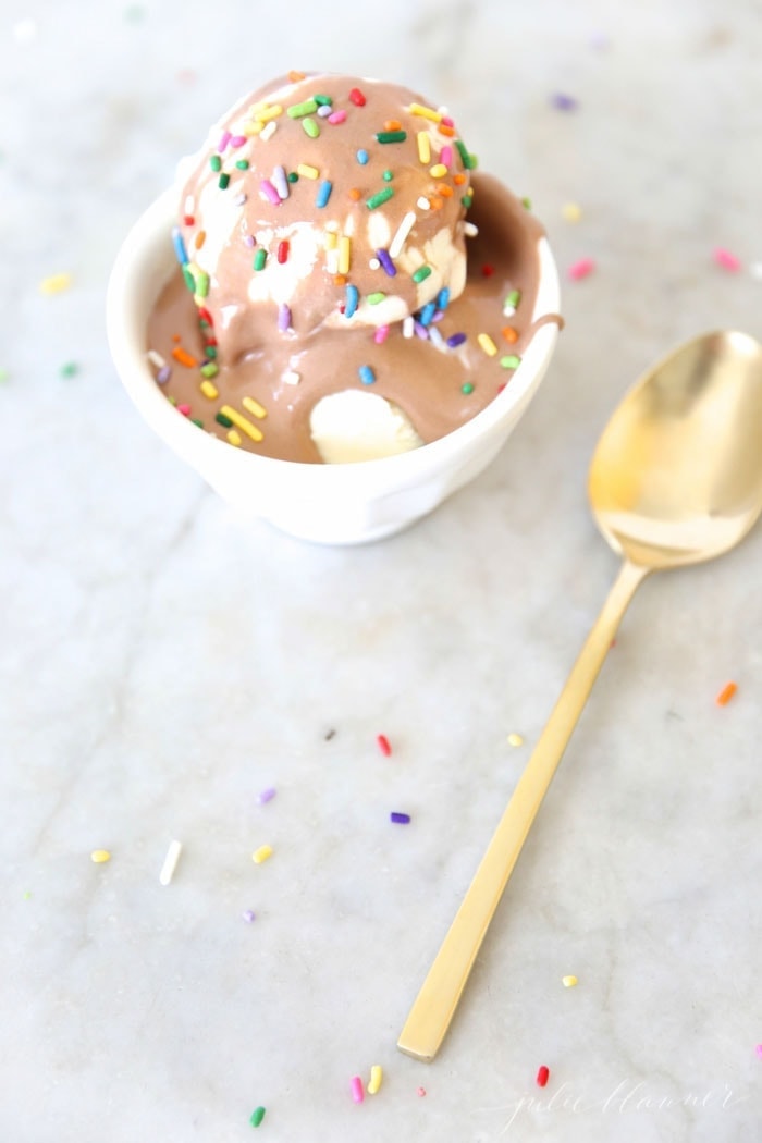 Chocolate sauce served on top of ice cream with sprinkles
