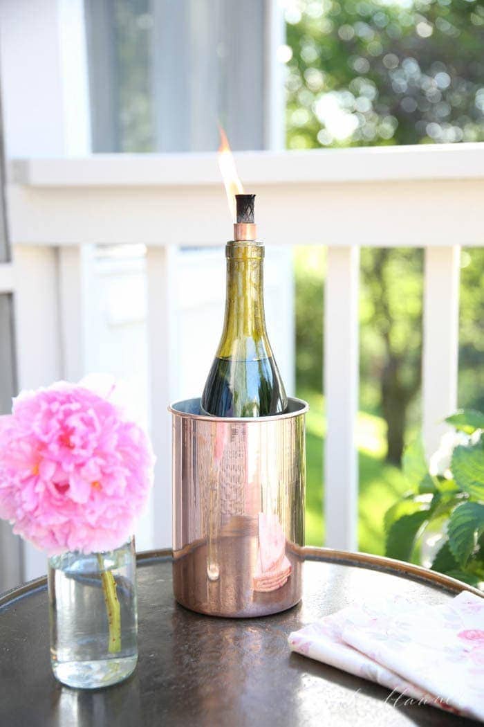 Learn how to make a wine bottle tiki torch in less than 10 minutes. Keep bugs at bay with one of these beautiful wine bottle crafts!