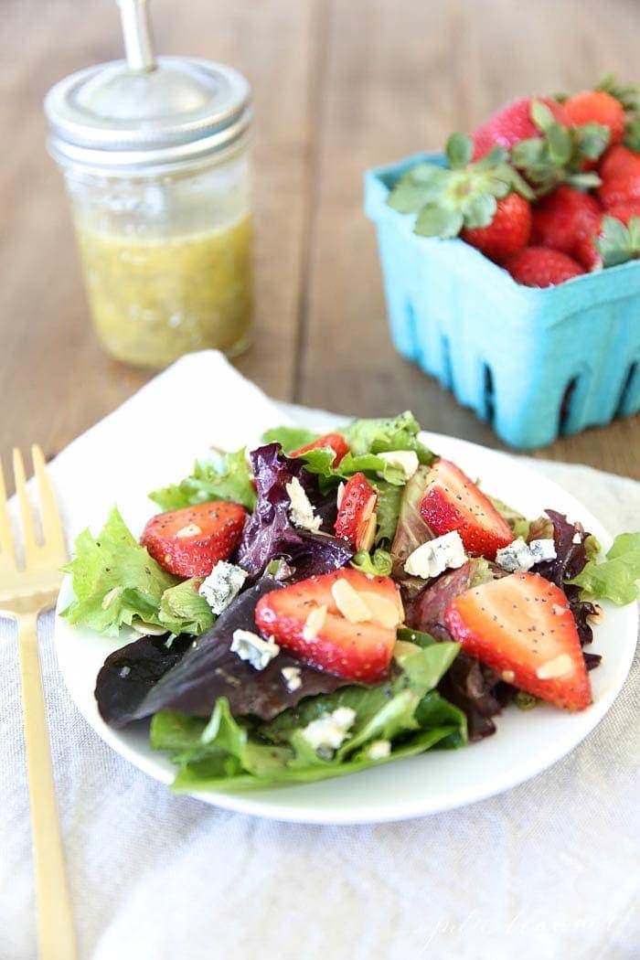 Strawberry salad with poppy seed dressing served with a fork