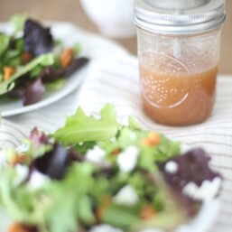 raspberry vinaigrette in mason jar with salad with text overlay