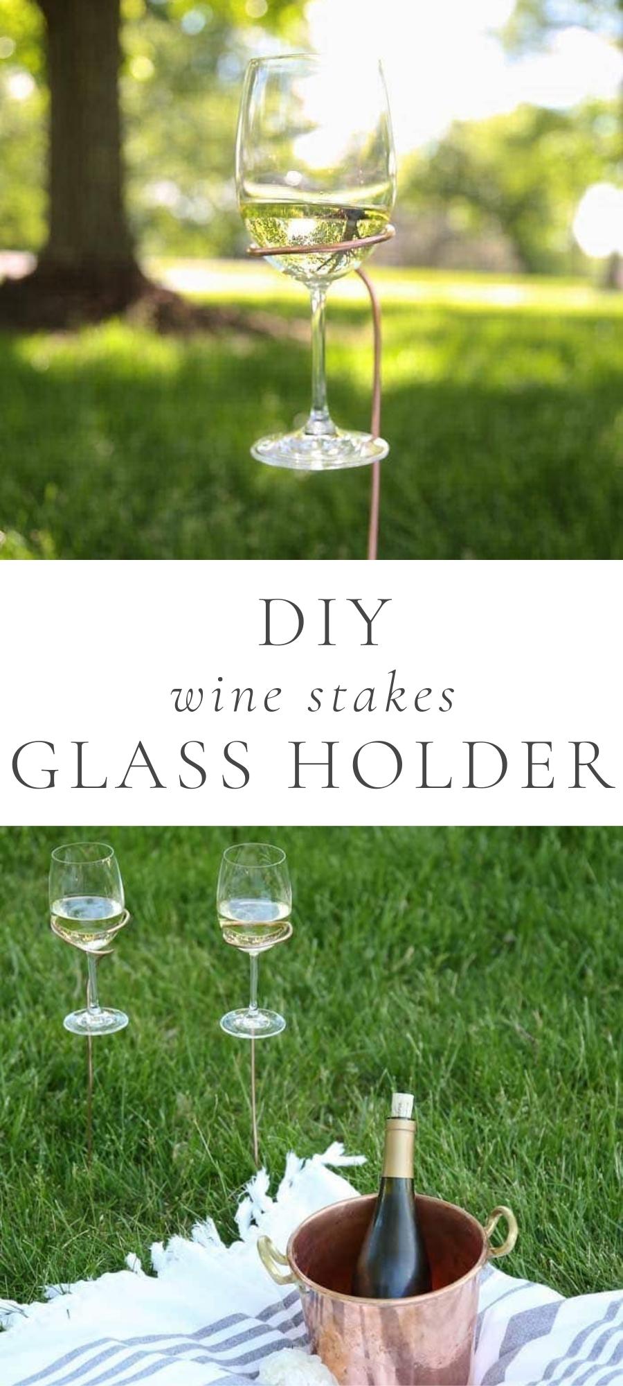 glass of wine in glass holder I grass and wine bucket on blanket