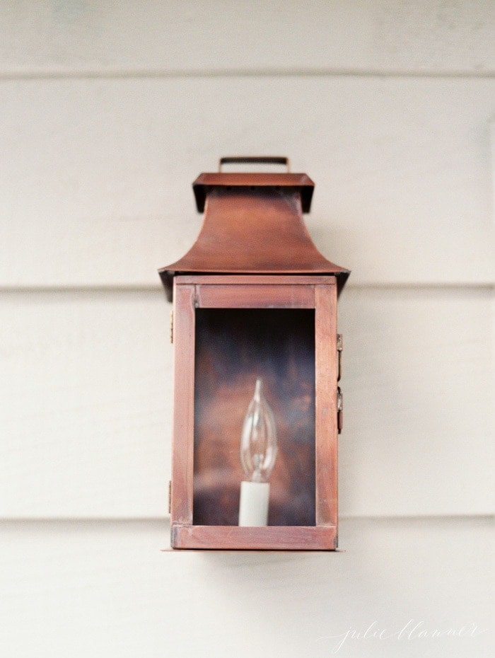 A copper lantern on the exterior of a home.
