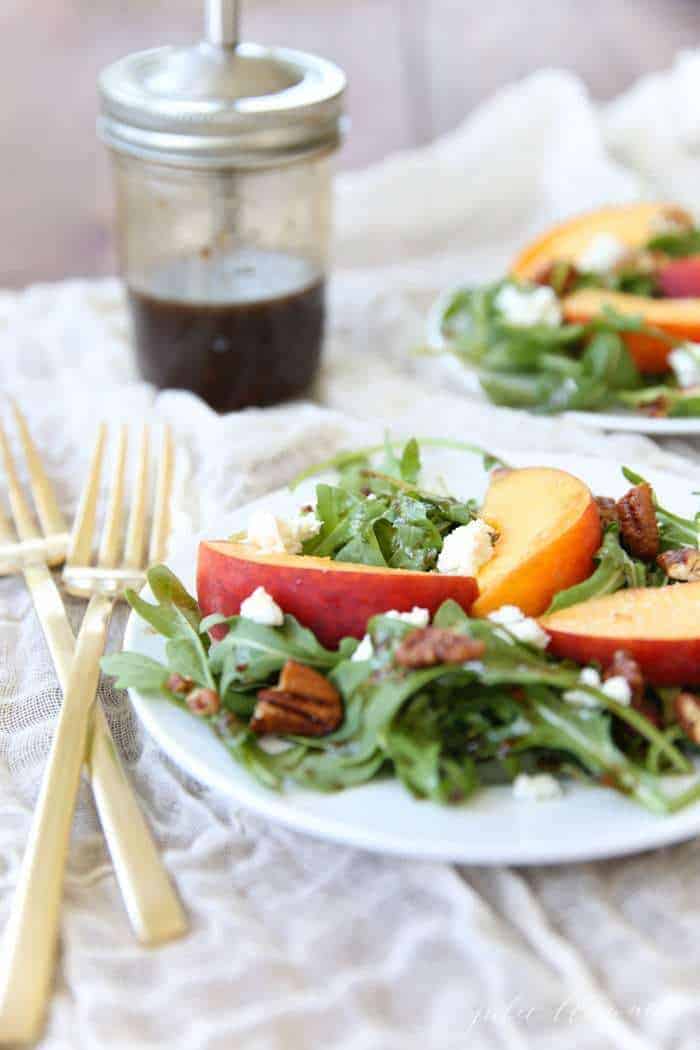 A white plate filled with a fresh green salad