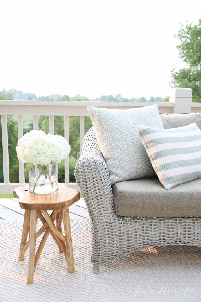 light colored deck with an ivory rug and beautiful outdoor furniture