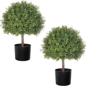 Two small, round artificial topiary trees with green leaves in black porch planter pots are placed side by side against a white background.