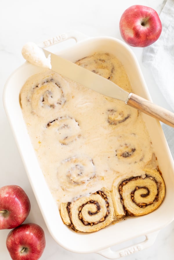 Apple cinnamon rolls featuring a delightful combination of apples and warm spices baked to perfection in a dish.