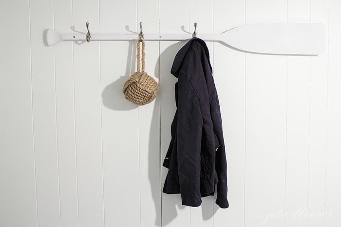 A coat and a purse hanging on a wall