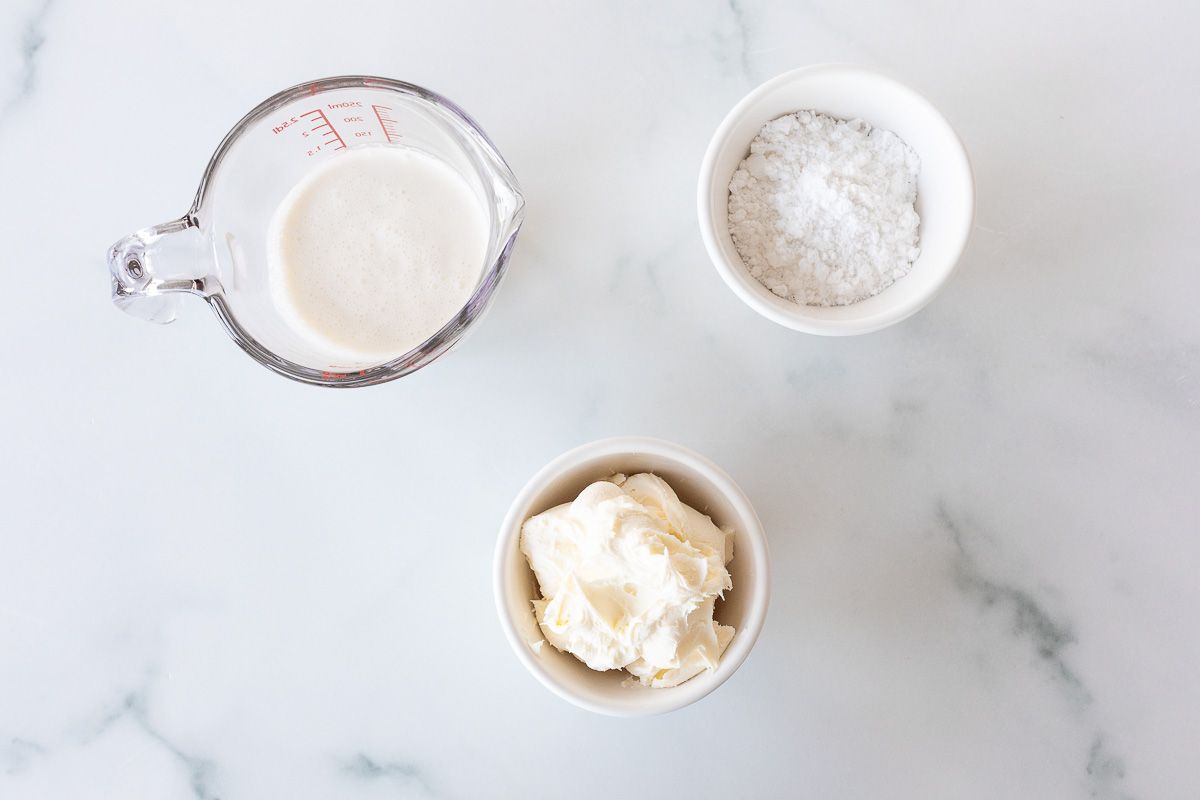 Ingredients for mascarpone cream laid out on a marble surface