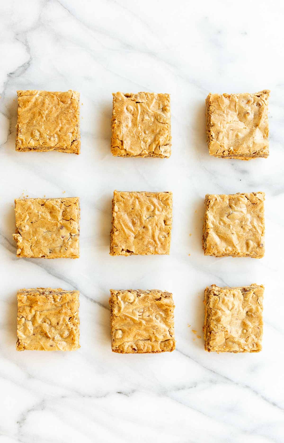 Peanut butter brownies cut into squares and spread out on a marble surface