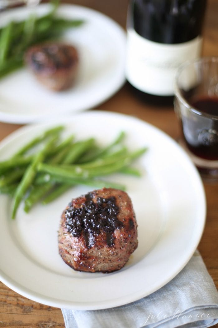 An incredible Red Wine Sauce for Steak that can be made in less than 20 minutes! Whether you call it red wine jus or gravy, its such an elegant meal! steak with red wine gravy and green beans on white plate