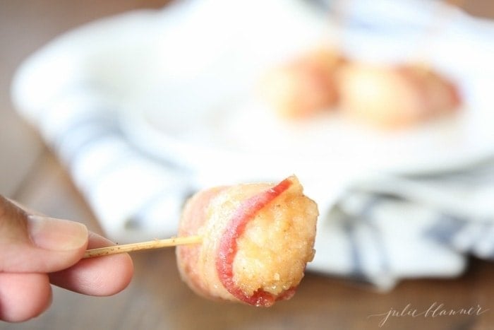 A Bacon Wrapped Chicken Bite on a cocktail stick