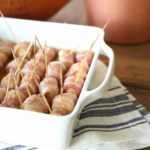Bacon wrapped pretzels in a white dish with toothpicks, a delectable twist on an easy appetizer.