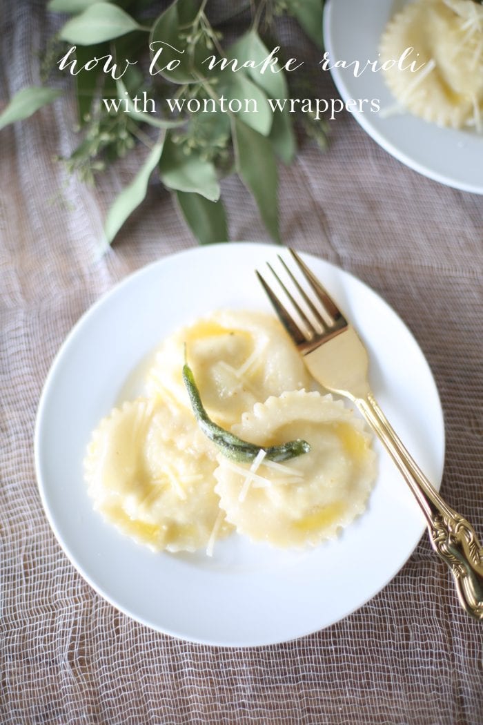 wonton ravioli with butter sage sauce on a white plate with gold fork