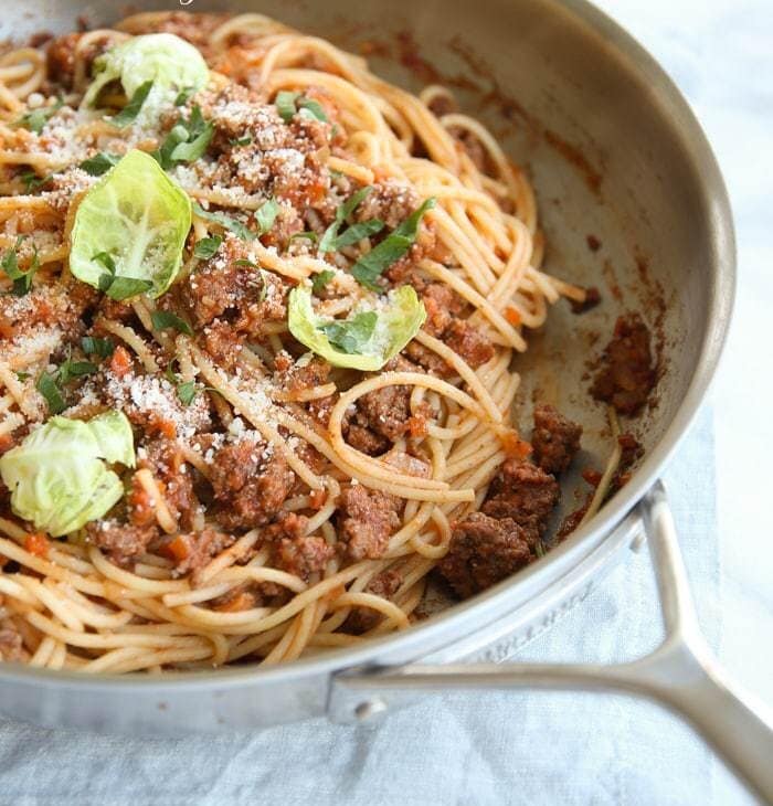 easy bolognese sauce recipe with spaghetti in skillet with text overlay