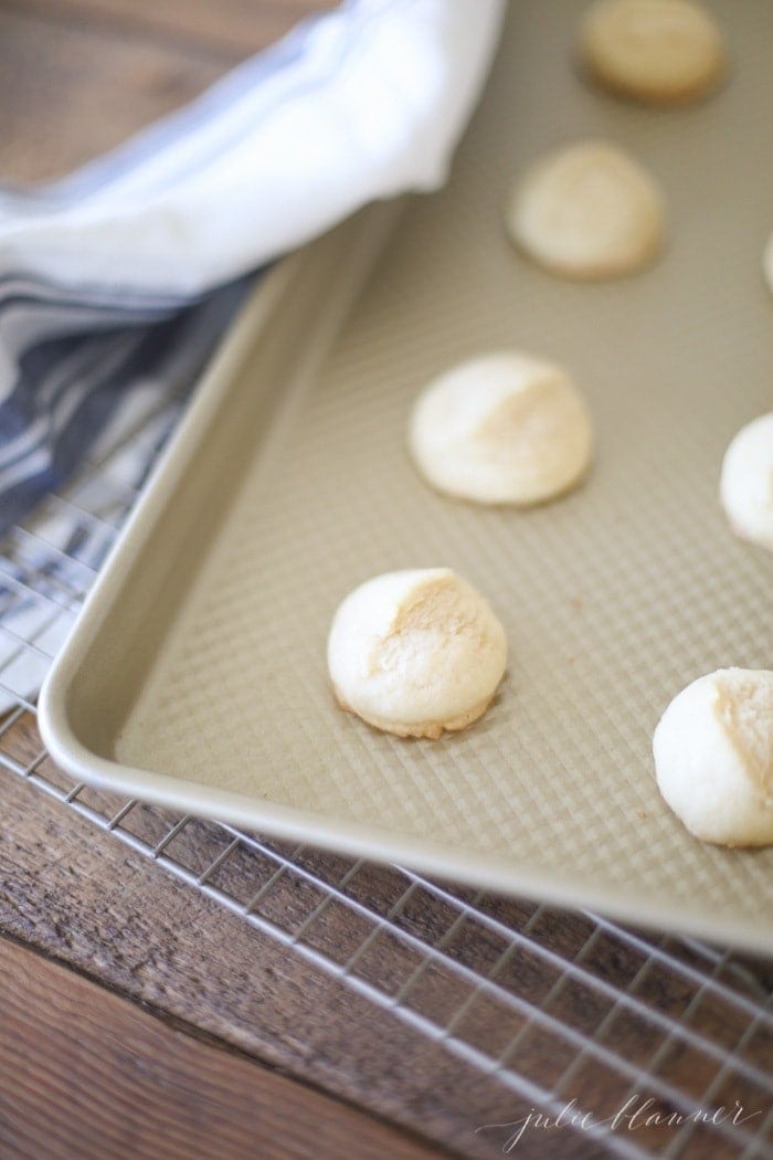 Browned Butter Sugar Cookies on a gold baking sheet.