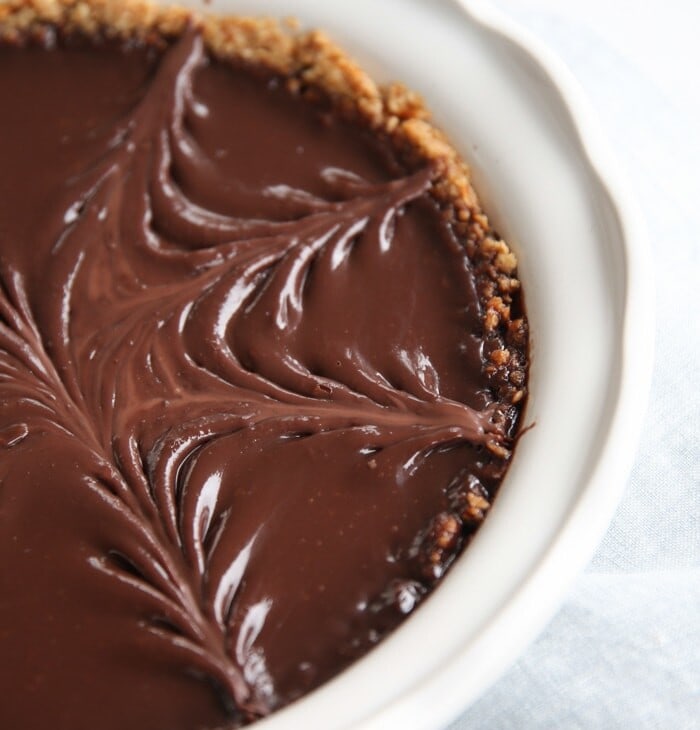pretzel crust pie with chocolate filling in white baking dish