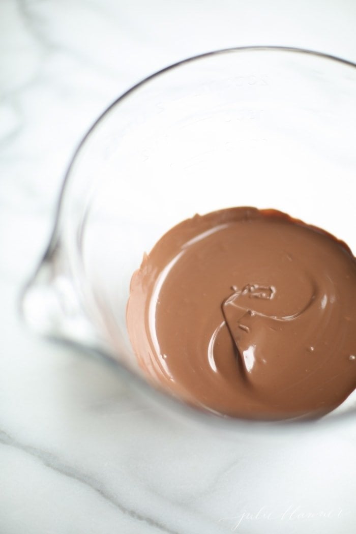 melted chocolate in clear pourable mixing bowl