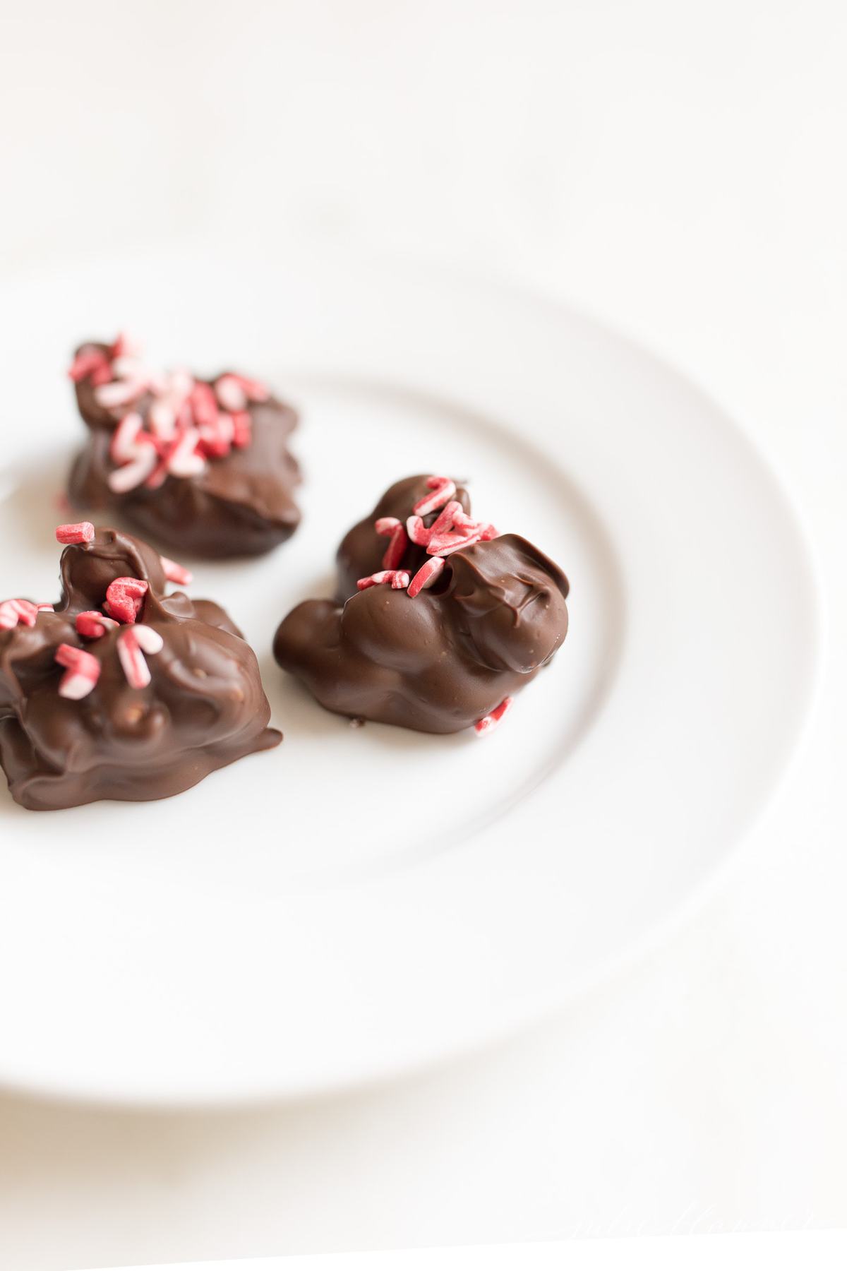 3 peanut clusters with sprinkles on a plate