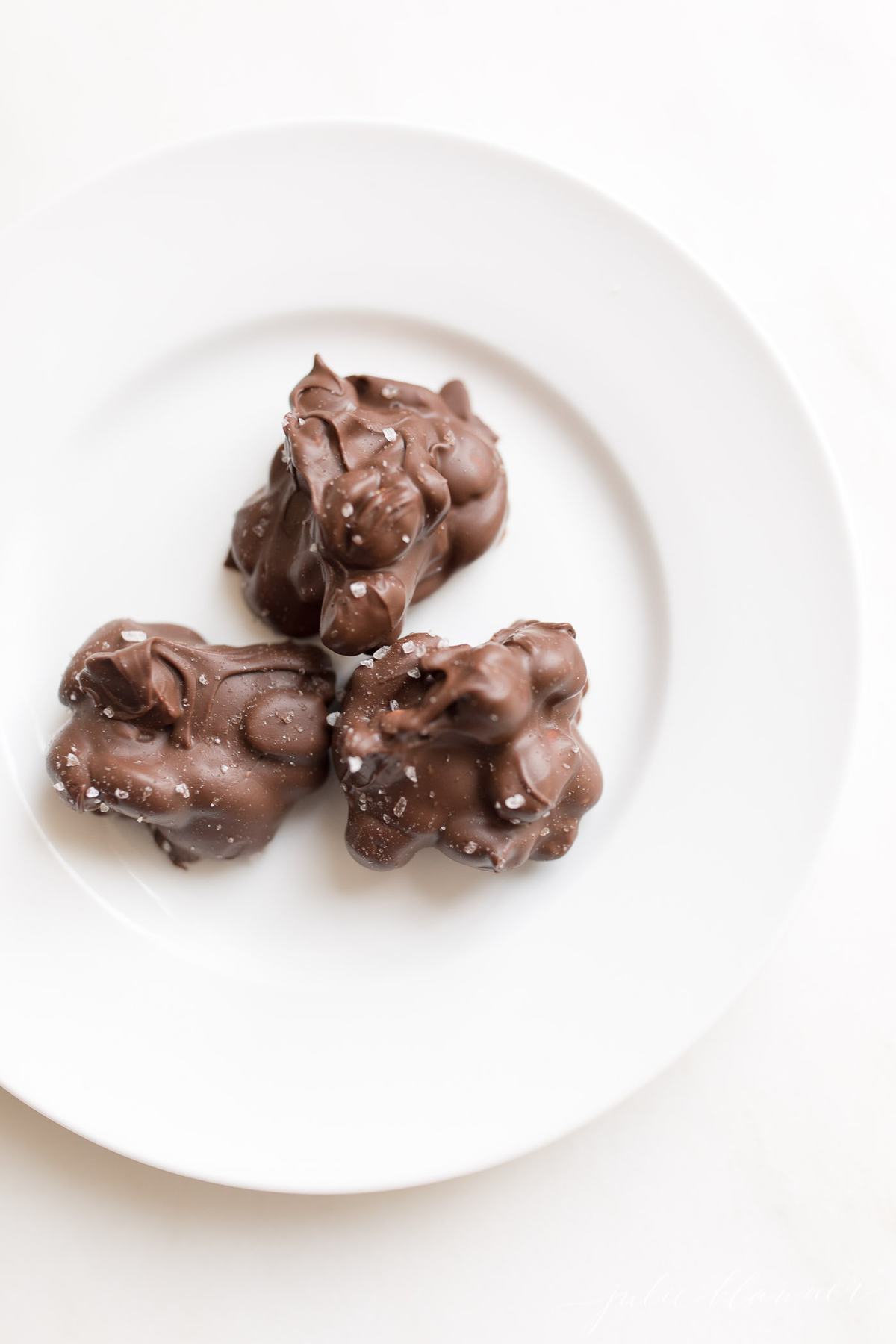 3 peanut clusters on a white plate