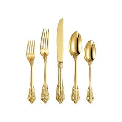 A set of gold forks and spoons arranged elegantly on a white background, perfect for a Christmas candle centerpiece.